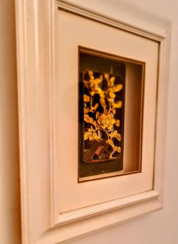 a framed picture of a flower on a wall at Boat House Super Suites in Rothesay
