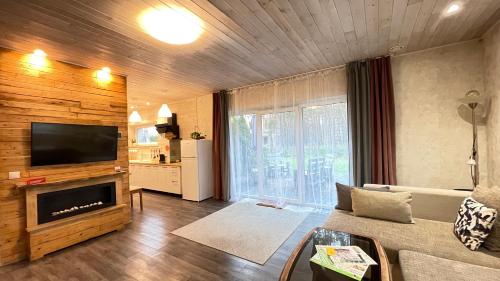 a living room with a couch and a flat screen tv at Lauku iela 25 in Jūrmala