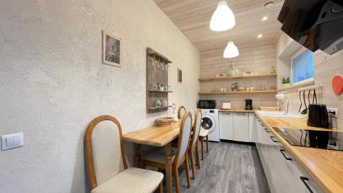 a kitchen with a wooden table and chairs at Lauku iela 25 in Jūrmala
