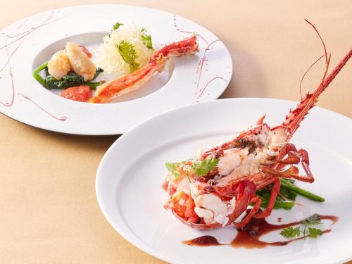 two plates of food with lobster on a table at Kobe Seishin Oriental Hotel in Kobe