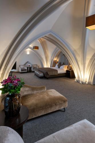 a large room with two beds and a couch and a table at Martin's Patershof in Mechelen
