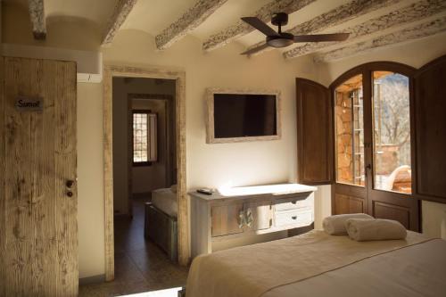 a bedroom with two beds and a ceiling fan at Mas del Sord 1335 in La Selva del Camp