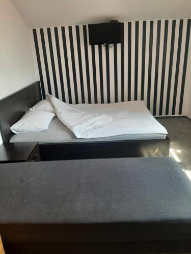 a bedroom with two beds and a black and white striped wall at Zielone Zacisze in Zagnańsk