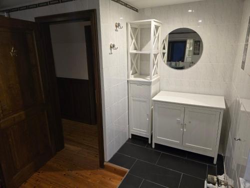 a bathroom with a white sink and a mirror at Cosy House in Dippach