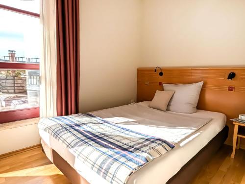 Ένα ή περισσότερα κρεβάτια σε δωμάτιο στο Boulevard Hotel Altstadt Schwerin