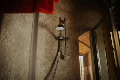 a shower in the corner of a bathroom with a mirror at Old Oak Farm in Oakham