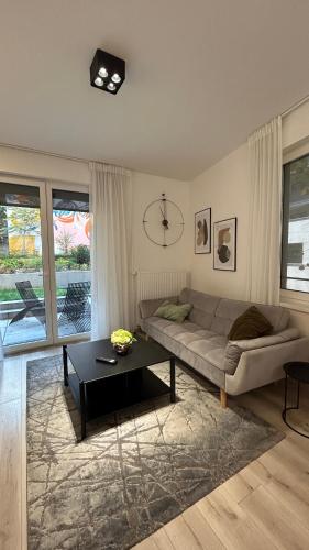 a living room with a couch and a table at LemonNing Condo in Budapest