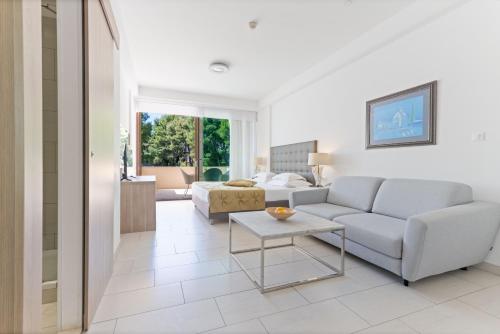 a living room with a couch and a table at The Residence Aparthotel in Podstrana