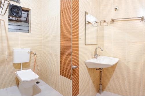 a bathroom with a toilet and a sink at FabHotel Shree Swami, Nr Bird Valley Udyan in Pune