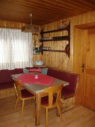 a dining room with a table and chairs and wine bottles at Turner-Hütte in Heiligenblut