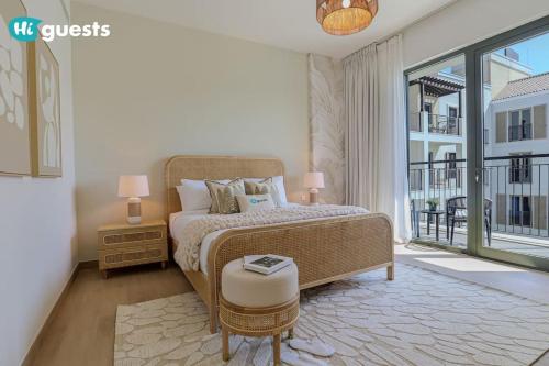 a bedroom with a bed and a large window at HiGuests - Beachfront Living Stunning 4 BR with Maid's Room in Dubai