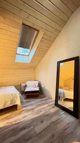 a room with two beds and a mirror at Lauku iela 25 in Jūrmala