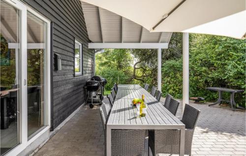 a table on a porch with a toy on it at Lovely Home In Tisvildeleje With Sauna in Holløselund