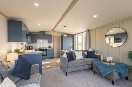 a living room with two couches and a kitchen at Host & Stay - Riverwood, Ashdown Retreat in Pickering