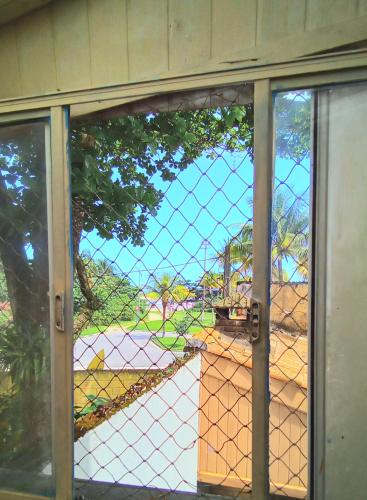 a glass door with a view of a construction site at Residencial Praia Bertioga Pé na Areia in Bertioga