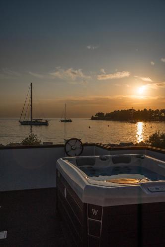 a hot tub with a view of the water and boats at The Sea Lodges Novigrad - Hausboot Floating Sea House in Novigrad Istria