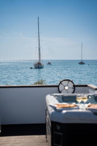 a table with a view of the ocean with boats at The Sea Lodges Novigrad - Hausboot Floating Sea House in Novigrad Istria
