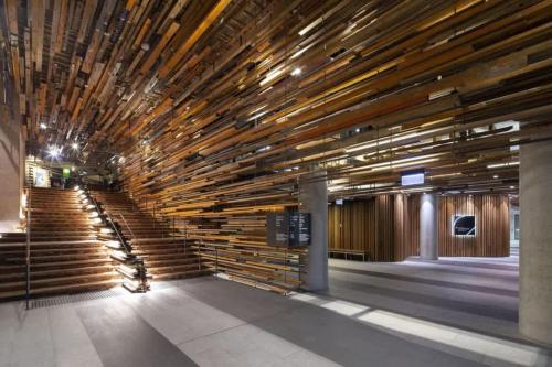 a lobby with wooden stairs in a building at Nishi-Execs Couples and family retreat in Canberra
