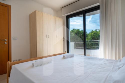 a bedroom with a large bed with a large window at Homiday - Holiday Rendez Vous in Pineto