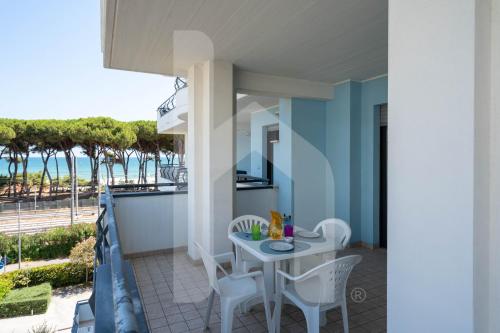 a balcony with a table and chairs and the ocean at Homiday - Holiday Rendez Vous in Pineto