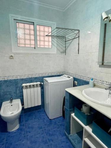a blue and white bathroom with a toilet and a sink at CarreraHouses Benilde con Garaje in Vigo