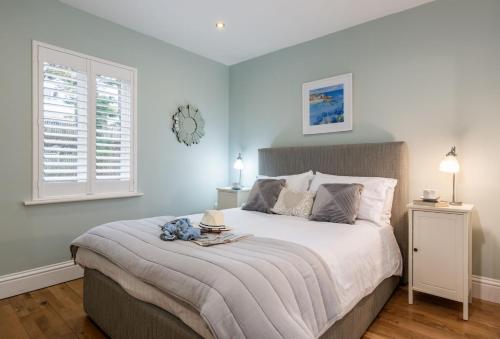 a bedroom with a large bed with a clock on the wall at The View in Carbis Bay