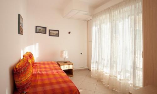 Ένα ή περισσότερα κρεβάτια σε δωμάτιο στο Casavacanze Internazionale