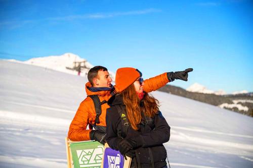 a man and a woman standing in the snow at Azureva Areches in Arêches