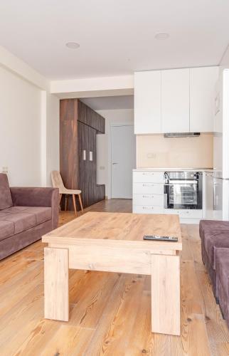 a living room with a wooden coffee table at 2-room apartment New Gudauri F1 in Gudauri