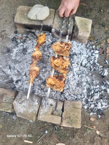 a group of food cooking on a grill at Happy Buriani in Buriaki