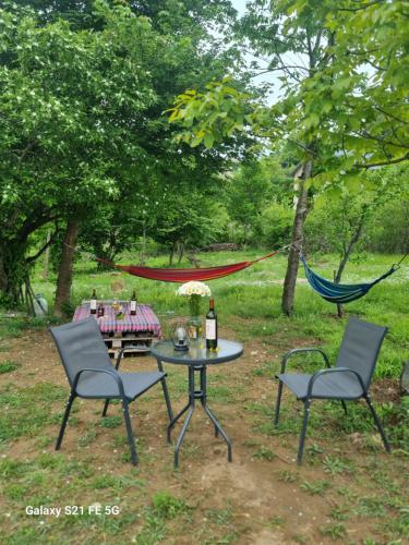 a picnic table and two chairs and a hammock at Happy Buriani in Buriaki