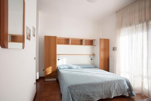 Ένα ή περισσότερα κρεβάτια σε δωμάτιο στο Casavacanze Internazionale