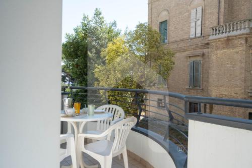 a balcony with a table and chairs on it at Homiday - Holiday Rendez Vous in Pineto
