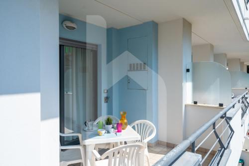 a room with a table and chairs on a balcony at Homiday - Holiday Rendez Vous in Pineto