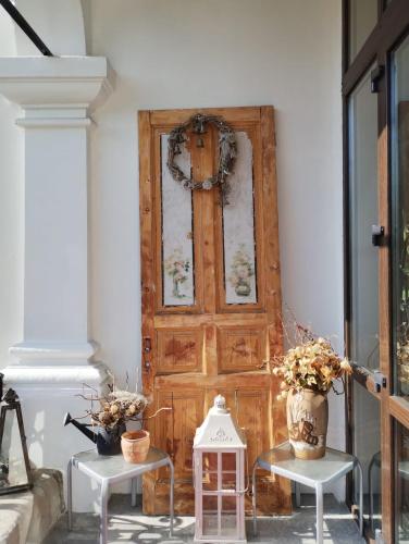 a wooden door with two tables in front of it at IL Piccolo Castello Busteni in Buşteni