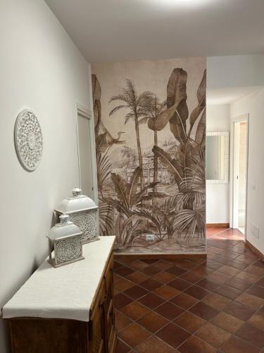 a bathroom with a mural of palm trees on the wall at Fly & Stay Apartments Fiumicino in Fiumicino