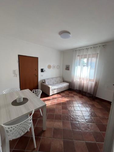 a living room with a table and a bed at Fly & Stay Apartments Fiumicino in Fiumicino