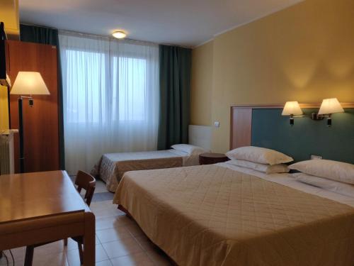 Postel nebo postele na pokoji v ubytování Albergo Conte Max