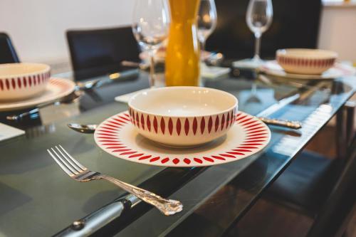 a table with a bowl and a plate with a fork at Bright House with Garden & Patio in Market Town in Inverurie