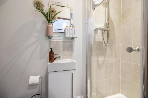 a bathroom with a sink and a shower at Bright House with Garden & Patio in Market Town in Inverurie