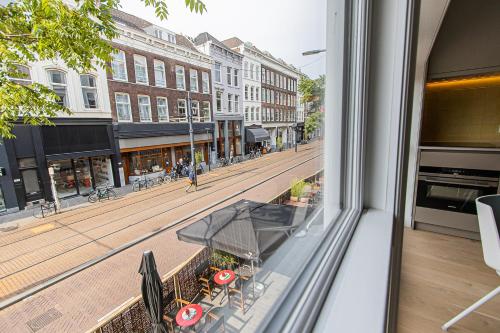 a view of a city street from a window at OHotellMe City Apartments Rotterdam in Rotterdam
