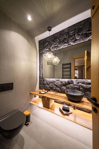 a bathroom with a sink and a mirror at Maison Michelangelo in Arachova