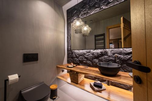 a bathroom with a sink and a mirror at Maison Michelangelo in Arachova