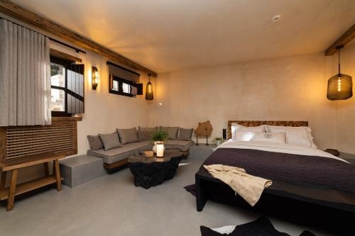 a bedroom with a large bed and a couch at Maison Michelangelo in Arachova