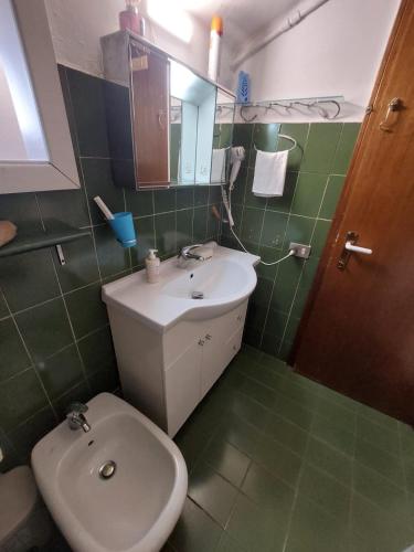 Un baño con un inodoro blanco y un lavabo. en Nido di Stella, en Zanica