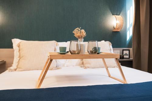 a wooden coffee table sitting on a bed at Easylife - FL Suite in Centrale in Milan