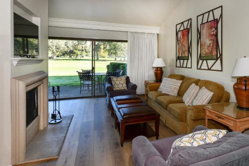 a living room with a couch and a fireplace at 656 Cottages at Silverado condo in Napa