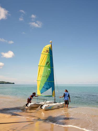 two people on the beach with a sail boat at East Winds St. Lucia- All Inclusive in Gros Islet