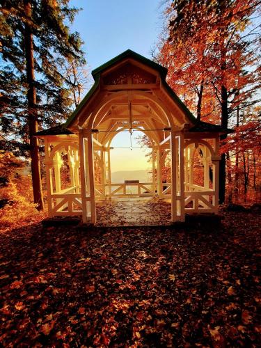a gazebo with the sunset in the background at Villa Rosenberg in Mariánské Lázně