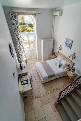 a bedroom with a bed and a large window at Hôtel l'Orangeraie in La Croix-Valmer